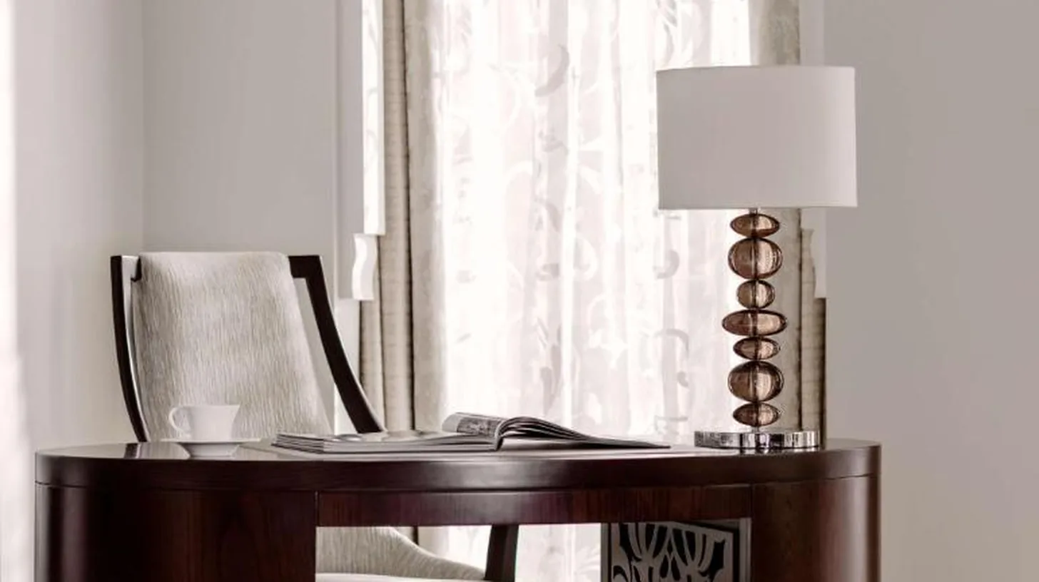 a desk with a chair and a lamp in a room at One&Only The Palm Dubai in Dubai