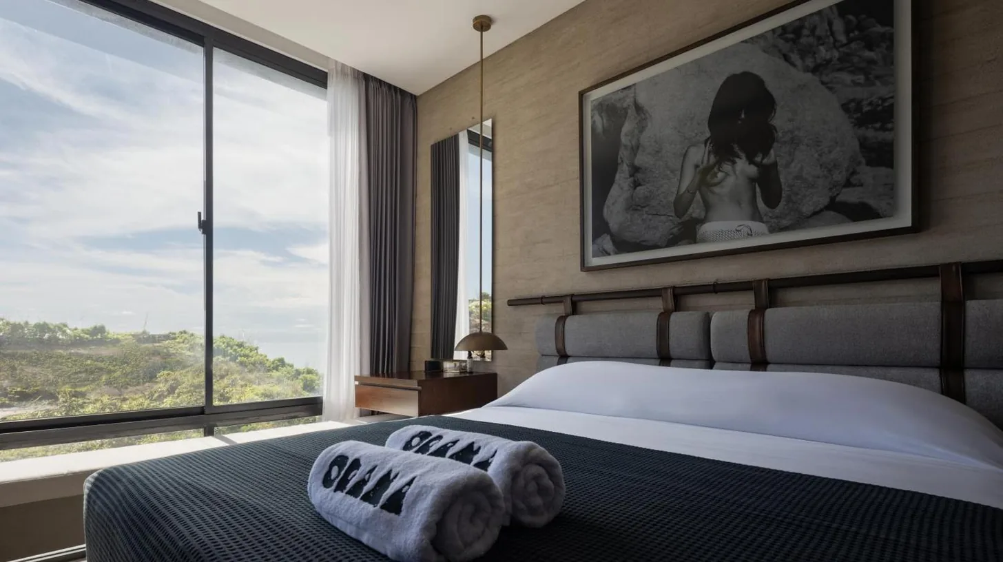 a bedroom with a couch in a room at Orama Bali in Uluwatu