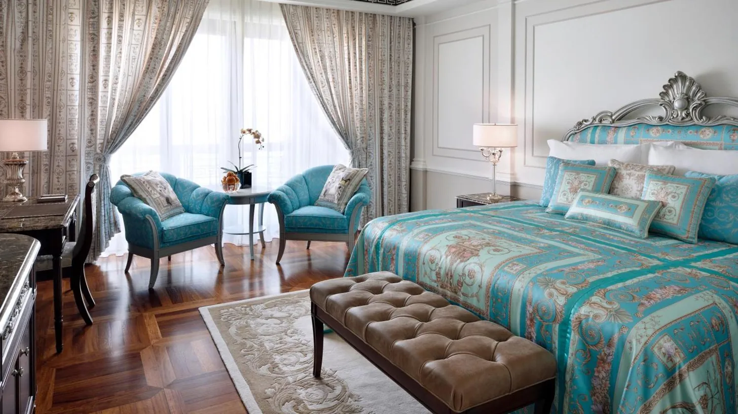 a bedroom with a bed and a living room at Palazzo Versace Dubai in Dubai