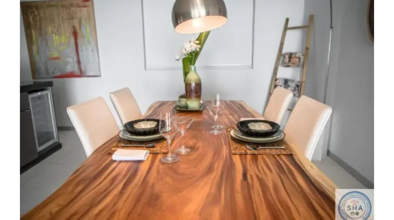 a dining room table with chairs and a vase on it at Panorama Samui Residences in Ban Bang Po
