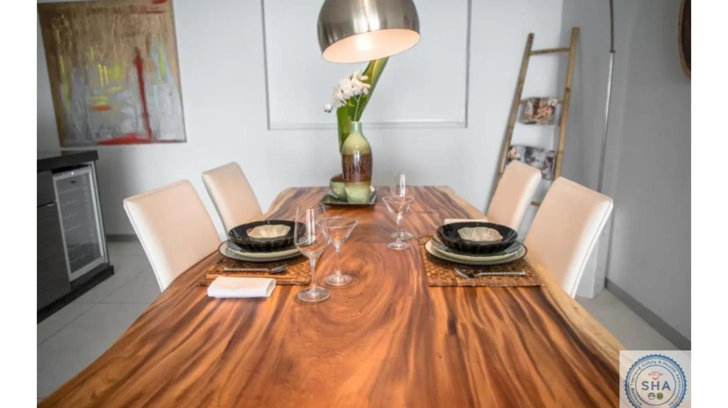 a dining room table with chairs and a vase on it at Panorama Samui Residences in Ban Bang Po
