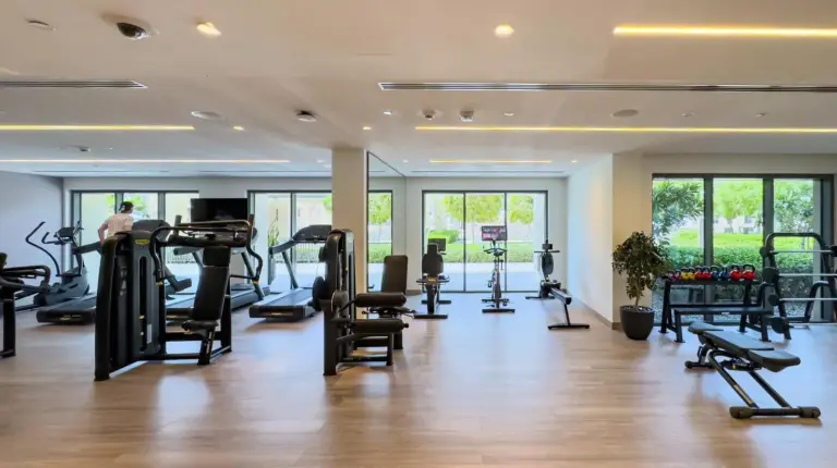 a gym with treadmills and exercise equipment in a building at Panoramic Burj Khalifa Views at Burj Royale by Propigo in Dubai