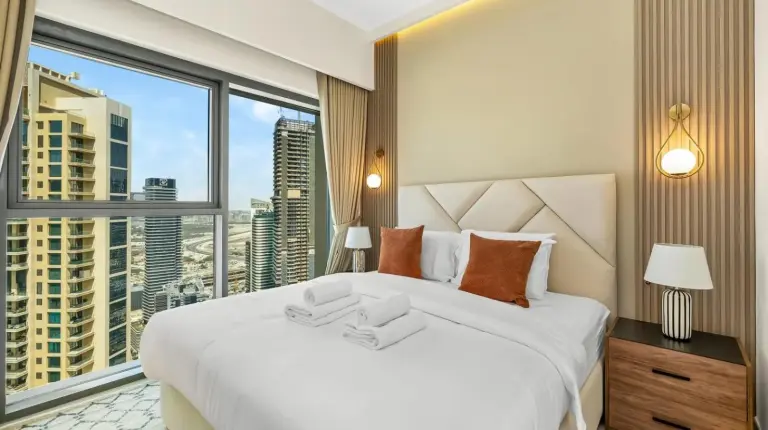 a bedroom with a large white bed and a large window at Panoramic Burj Khalifa Views at Burj Royale by Propigo in Dubai
