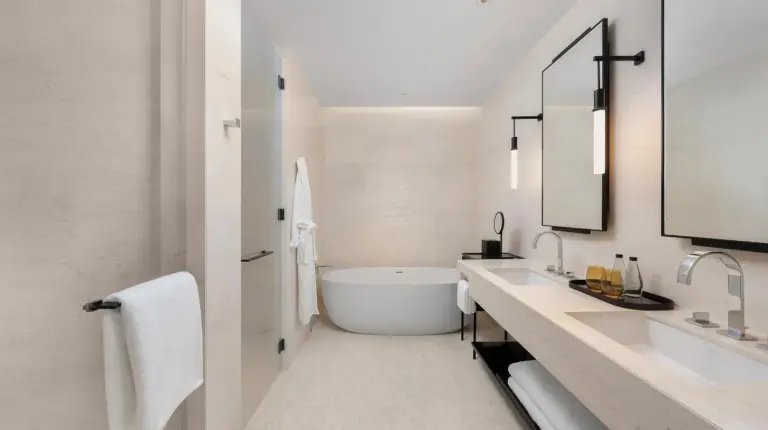 a white bathroom with a tub and a sink at Park Hyatt Bangkok in Bangkok