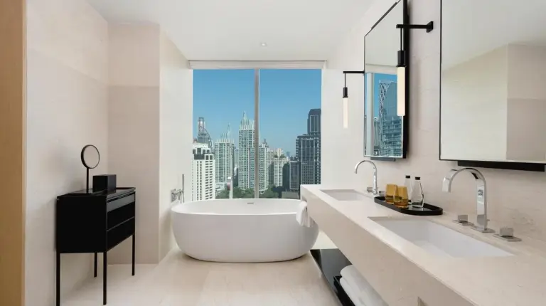 a bathroom with a large tub and a large window at Park Hyatt Bangkok in Bangkok