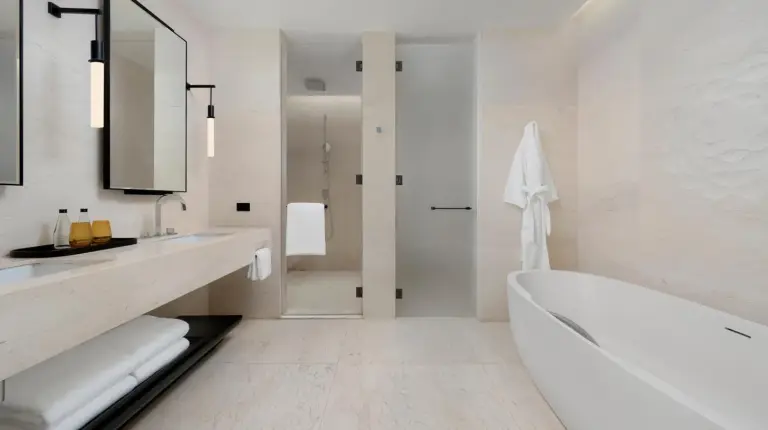 a bedroom with a large white bed and a television at Park Hyatt Bangkok in Bangkok