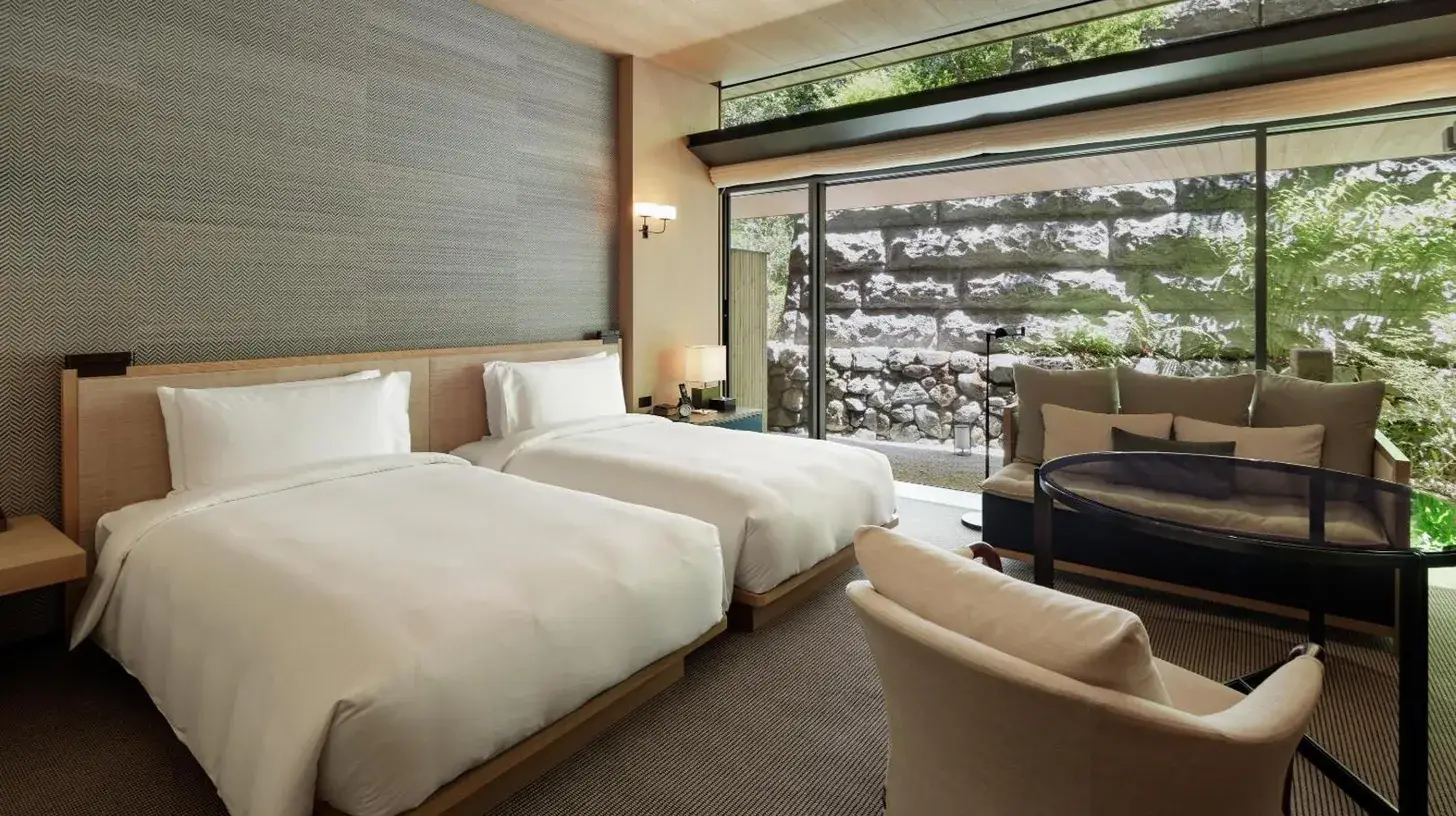 two beds in a room with a window at Park Hyatt Kyoto in Kyoto