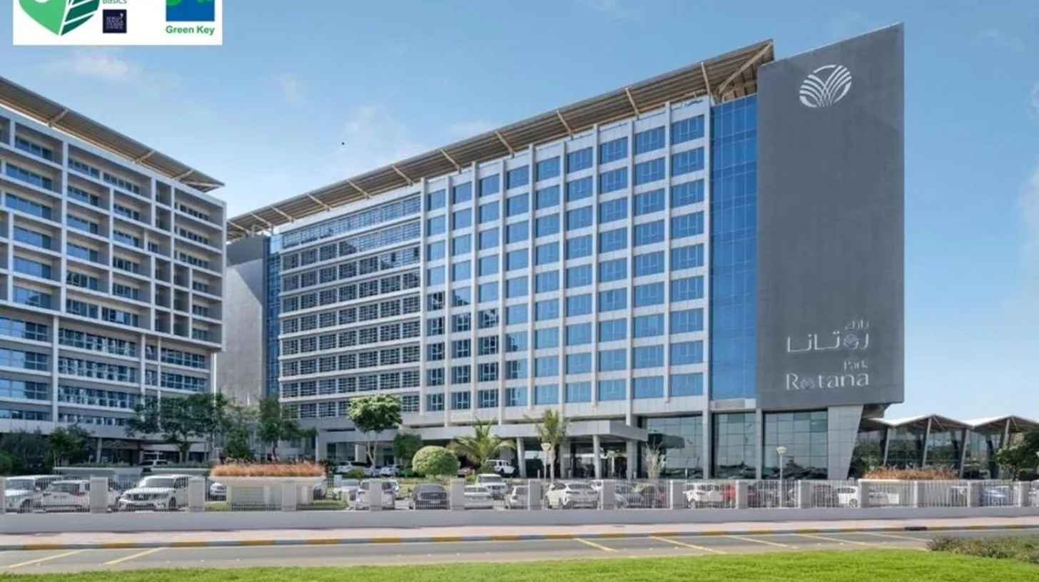 a rendering of a large building with cars parked outside at Park Rotana Abu Dhabi in Abu Dhabi