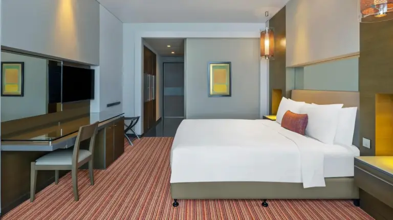 a hotel room with a bed and a desk at Park Rotana Abu Dhabi in Abu Dhabi
