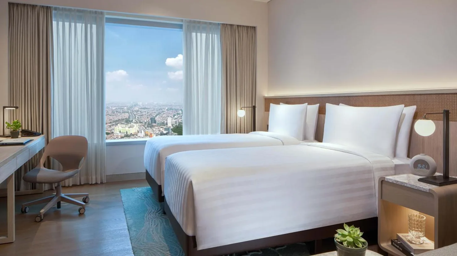 a kitchen with a washing machine and a sink at PARKROYAL Serviced Suites Jakarta in Jakarta
