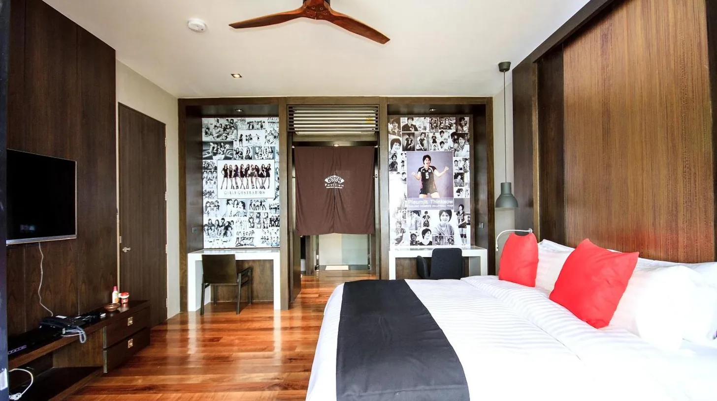 a bedroom with a large white bed with red pillows at Pavilion Pool Residence Samui - SHA Extra Plus in Lamai