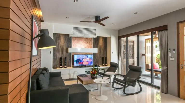 a living room with a couch and chairs and a tv at Pavilion Pool Residence Samui - SHA Extra Plus in Lamai