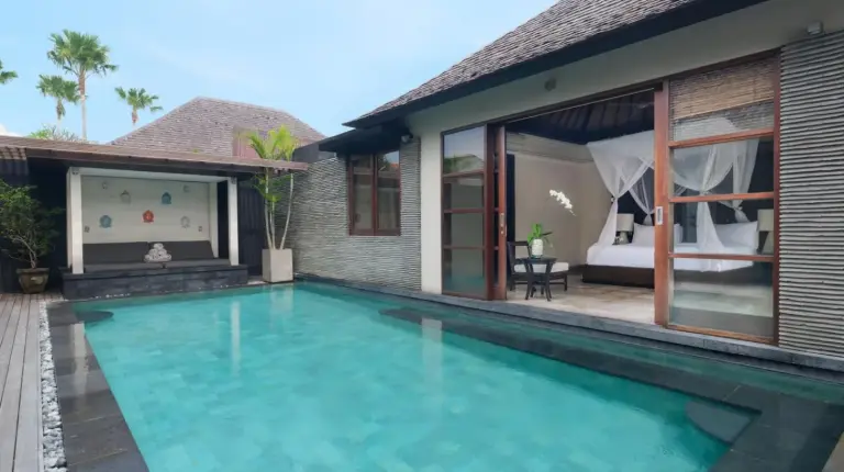 a bedroom with a bed with a hat on it at Peppers Seminyak in Seminyak
