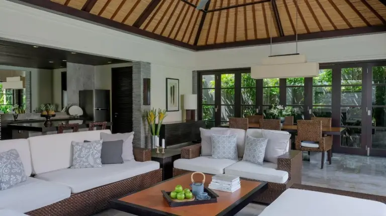 a living room with a couch and a swimming pool at Peppers Seminyak in Seminyak