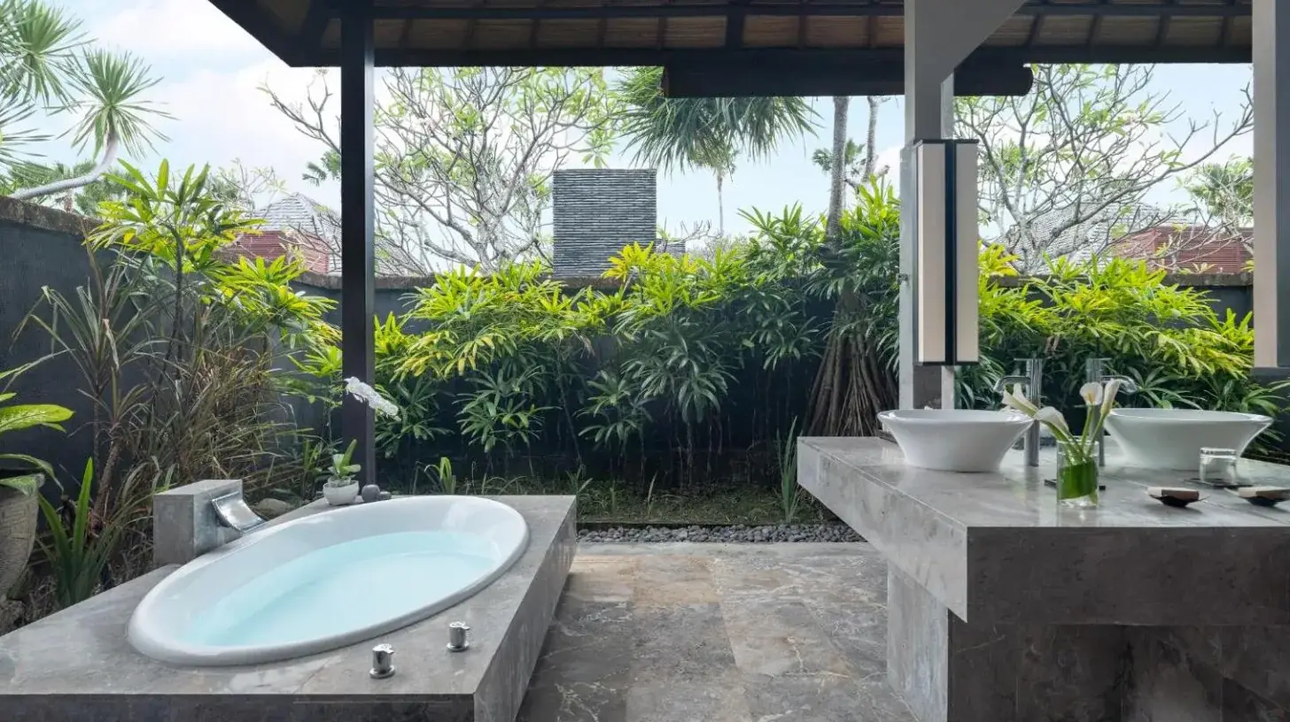 a hotel room with two beds and a tv at Peppers Seminyak in Seminyak