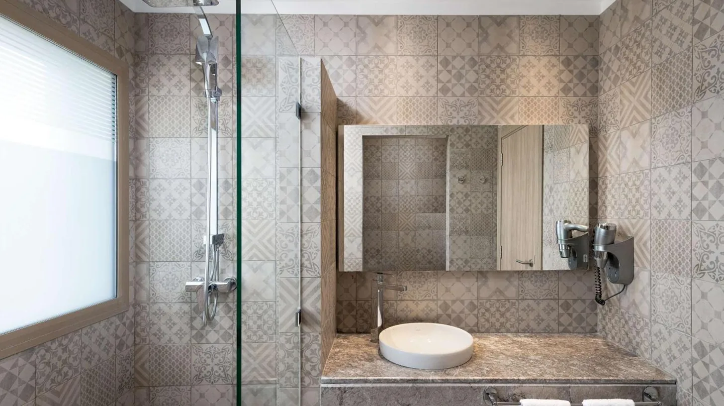 a bathroom with a shower with a toilet and a sink at Radisson Blu Resort Al Hoceima in Al Hoceïma