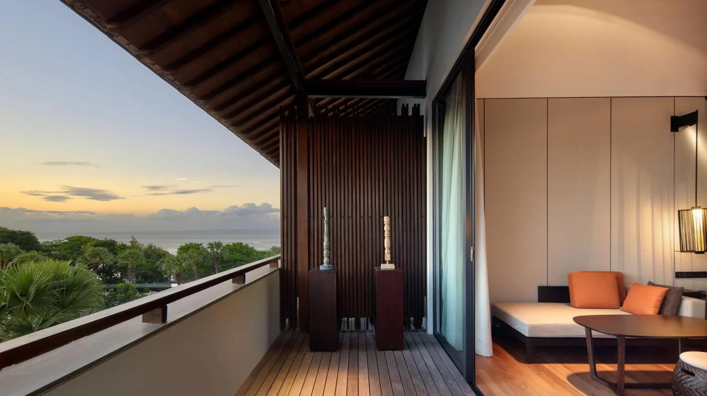 a balcony with a view of the ocean at Radisson Blu Resort & Villas Bali Uluwatu in Uluwatu
