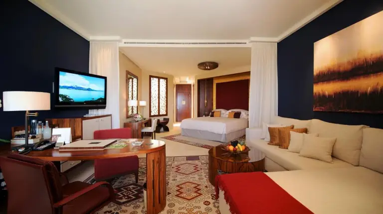an open door leading to a bathroom with a tub at Raffles Dubai in Dubai