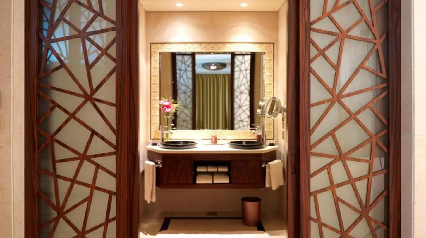 a bathroom with a sink and a mirror at Raffles Dubai in Dubai