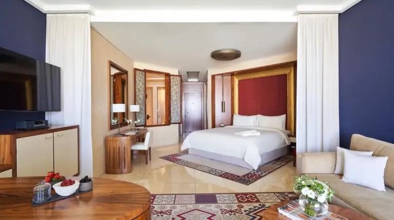 a bathroom with two sinks and a tub and a large mirror at Raffles Dubai in Dubai