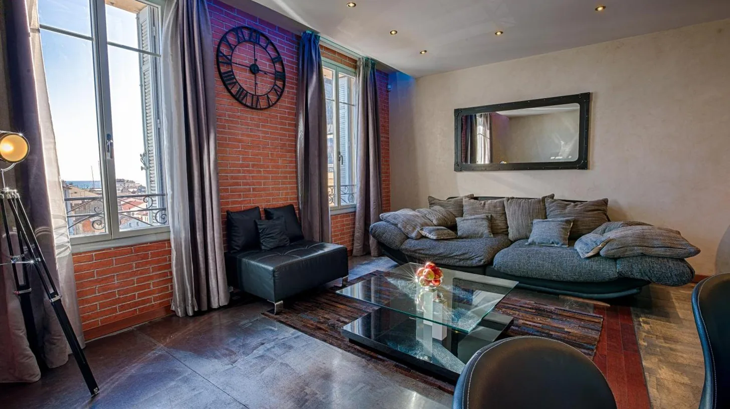 a living room with a couch and a glass table at Residence du Louvre - Apartments - Prime location Palais & Croisette - Luxury Stay by LRA Cannes in Cannes