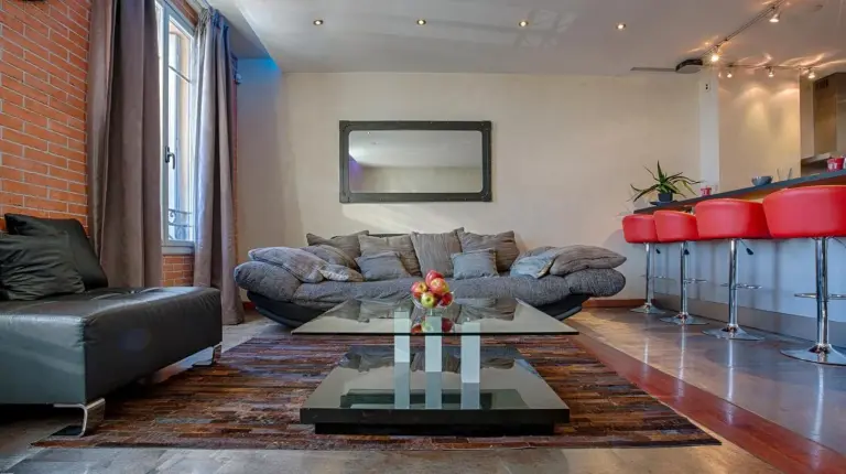 a living room with a table and a couch at Residence du Louvre - Apartments - Prime location Palais & Croisette - Luxury Stay by LRA Cannes in Cannes