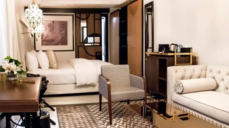 a bedroom with two beds and a table and a chair at Riad Dar Saba - Saba's House in Tangier