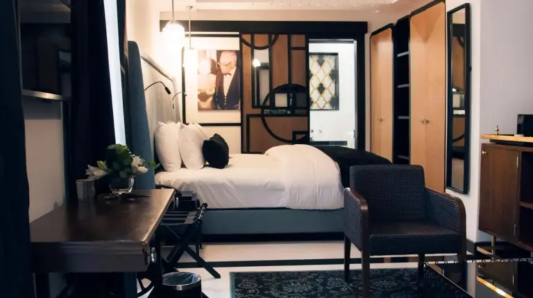 a bedroom with a bed and a desk and chair at Riad Dar Saba - Saba's House in Tangier