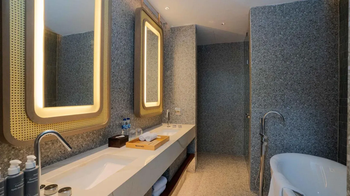 a kitchen with a counter with water bottles on it at Riahi by Swiss-Belhotel