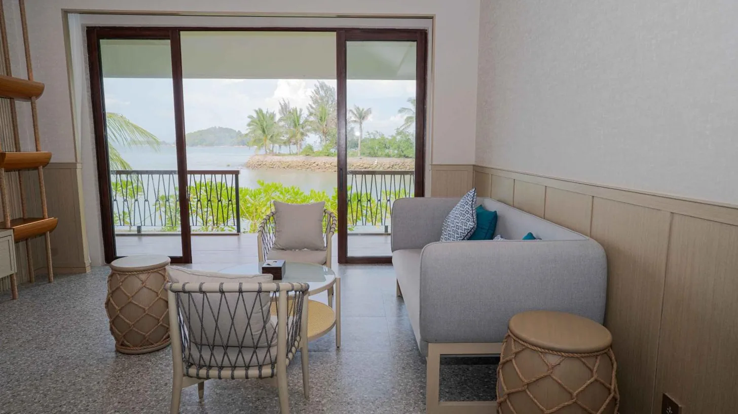 a bedroom with a large white bed and a large window at Riahi by Swiss-Belhotel