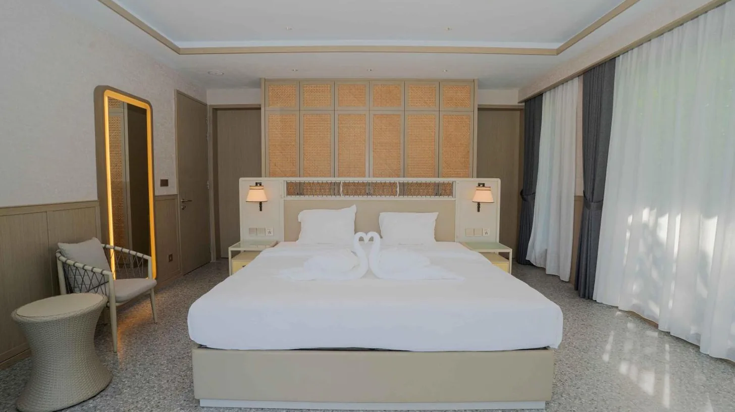 a bathroom with a tub and a sink and a mirror at Riahi by Swiss-Belhotel