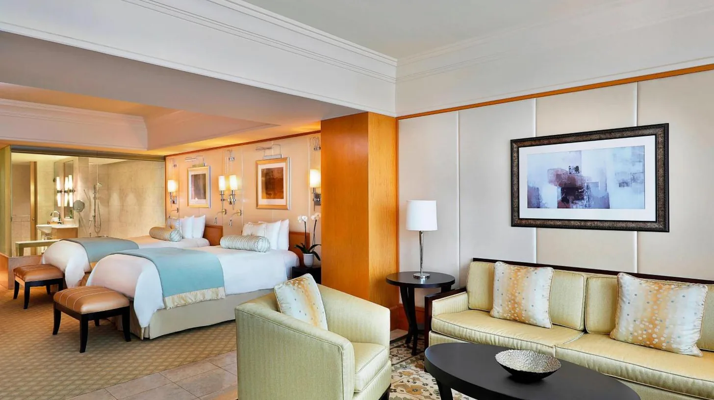 a hotel room with a bed and a living room at Ritz Carlton DIFC Downtown Dubai in Dubai