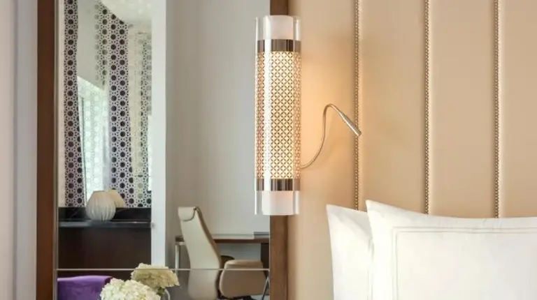a bedroom with a large white bed and a desk at Rixos Marina Abu Dhabi in Abu Dhabi