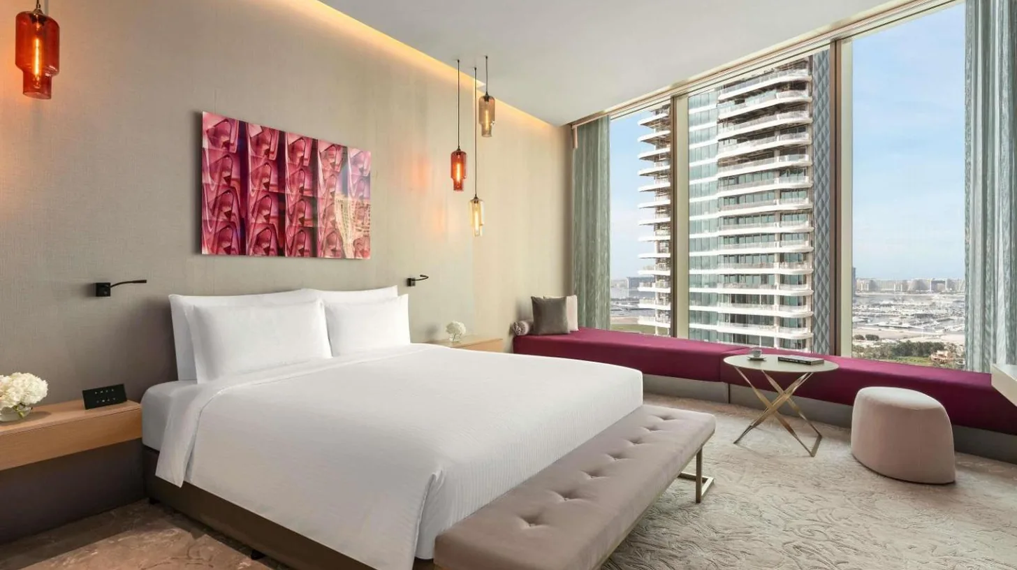 a bedroom with a large bed and a large window at Rixos Premium Dubai JBR in Dubai