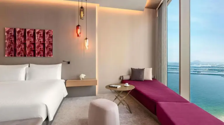 a hotel room with two beds and a large window at Rixos Premium Dubai JBR in Dubai