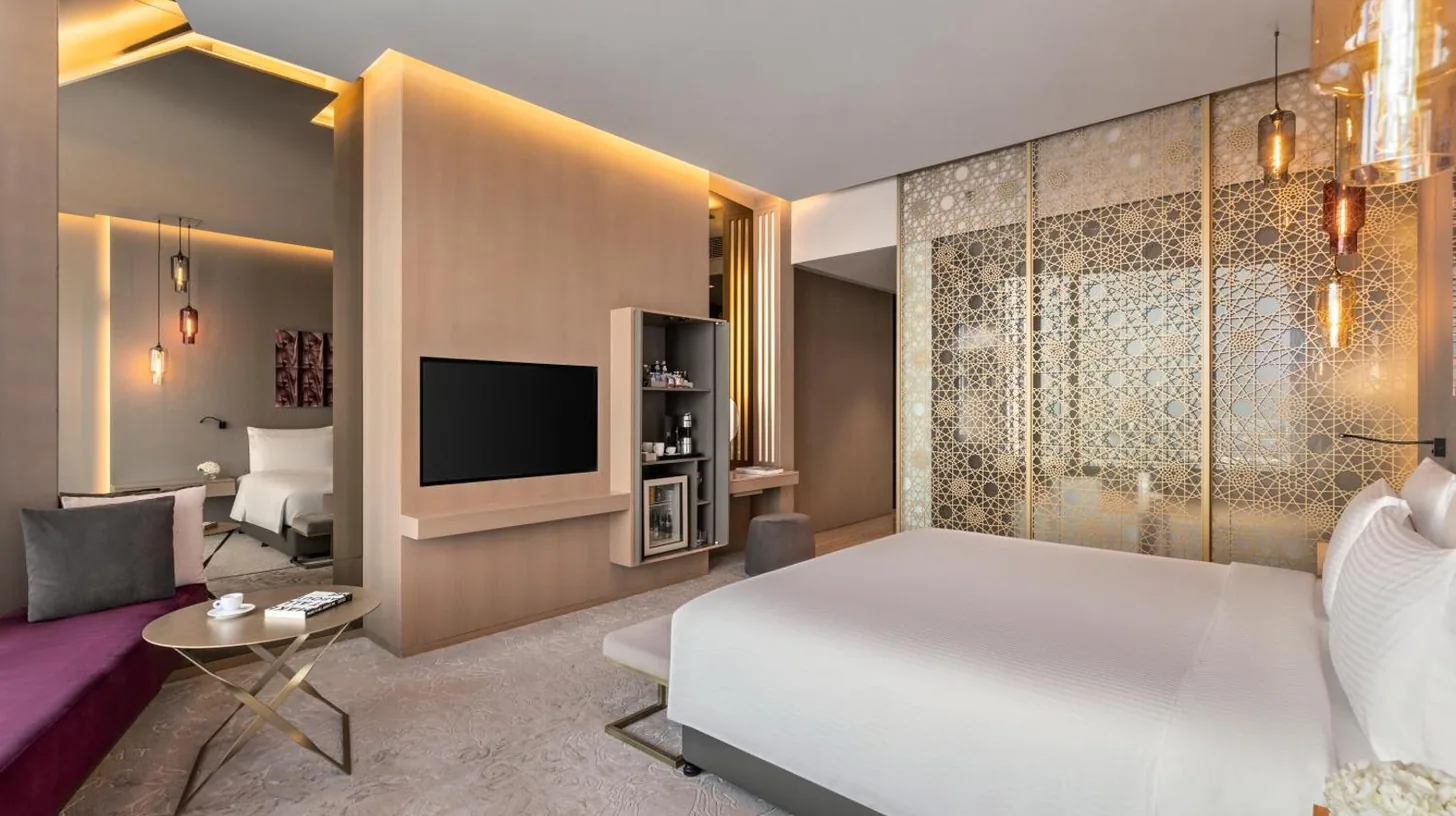 a hotel room with a bed and a large window at Rixos Premium Dubai JBR in Dubai