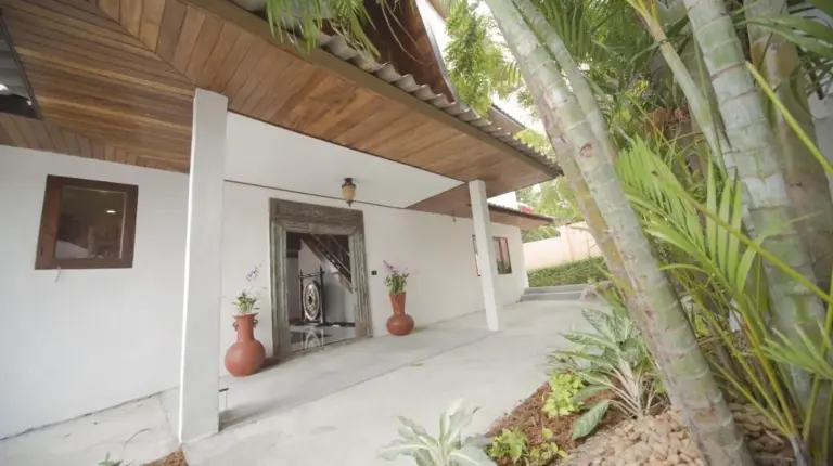 a porch of a house with a fireplace at Royal Majestic Grand Thai Villa in Choeng Mon Beach