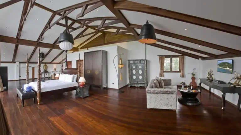 a bedroom with a bed and a piano in a room at Royal Majestic Grand Thai Villa in Choeng Mon Beach