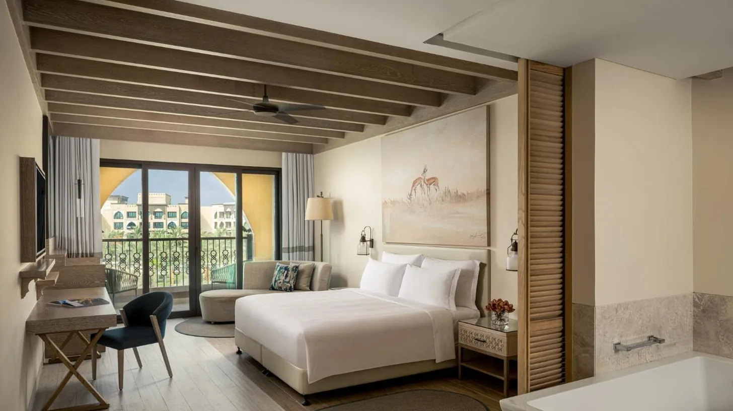 a hotel room with a bed and a bathroom at Saadiyat Rotana Resort and Villas in Abu Dhabi