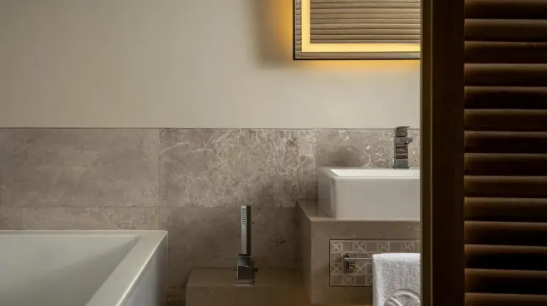 a bathroom with a bath tub and a sink at Saadiyat Rotana Resort and Villas in Abu Dhabi