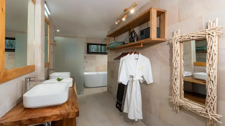 a villa with a swimming pool in front of a house at Samaraya Wellness Resort - Adults Only in Lipa Noi