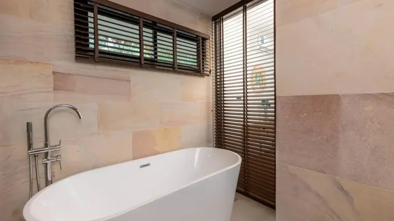 a bedroom with a large bed and large windows at Samaraya Wellness Resort - Adults Only in Lipa Noi