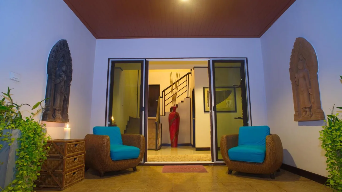 a living room with two chairs and a mirror at Samui Sunrise Seaview Villa in Chaweng