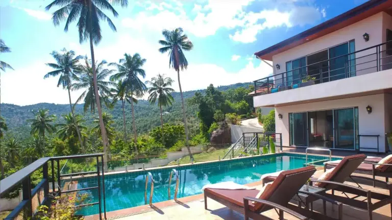 a villa with a swimming pool and palm trees at Samui Sunrise Seaview Villa in Chaweng
