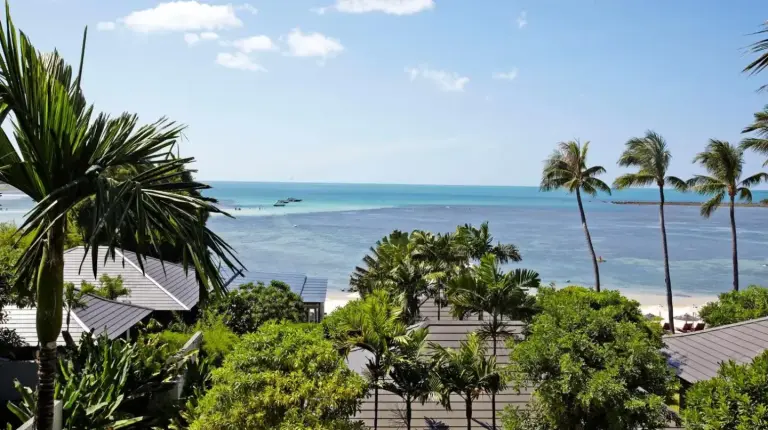 a view of a beach with palm trees and the ocean at Sareeraya Villas & Suites in Chaweng