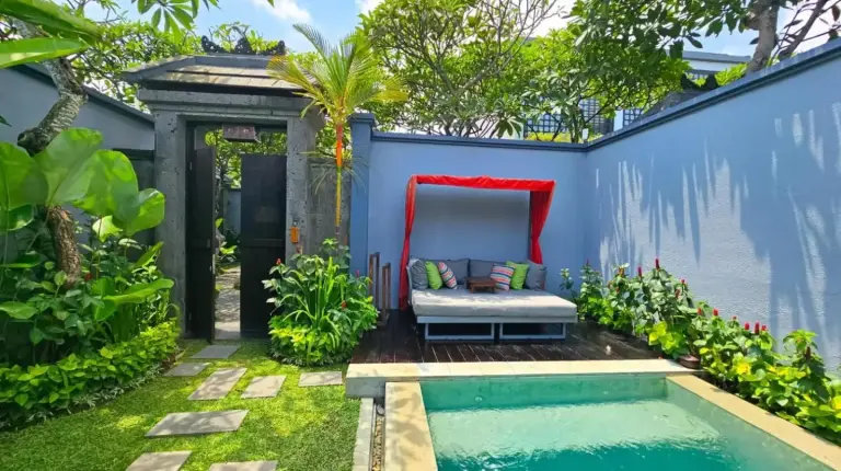 un patio trasero con una piscina y un banco junto a una casa en Seminyak Icon - by Karaniya Experience - CHSE certified en Seminyak