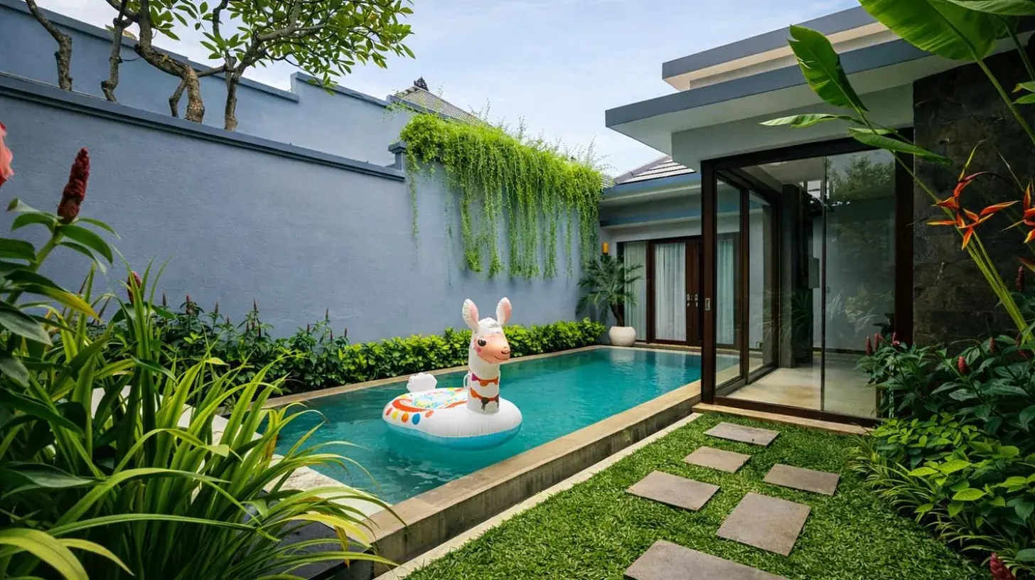 un patio trasero con una piscina con un perro en un limbo inflable en Seminyak Icon - by Karaniya Experience - CHSE certified en Seminyak
