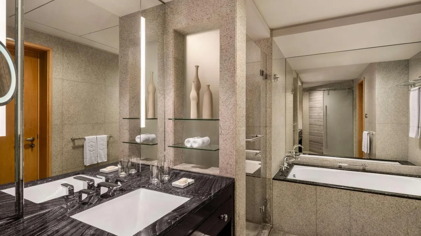 a bathroom with a sink and a large mirror at Shangri-La Dubai in Dubai