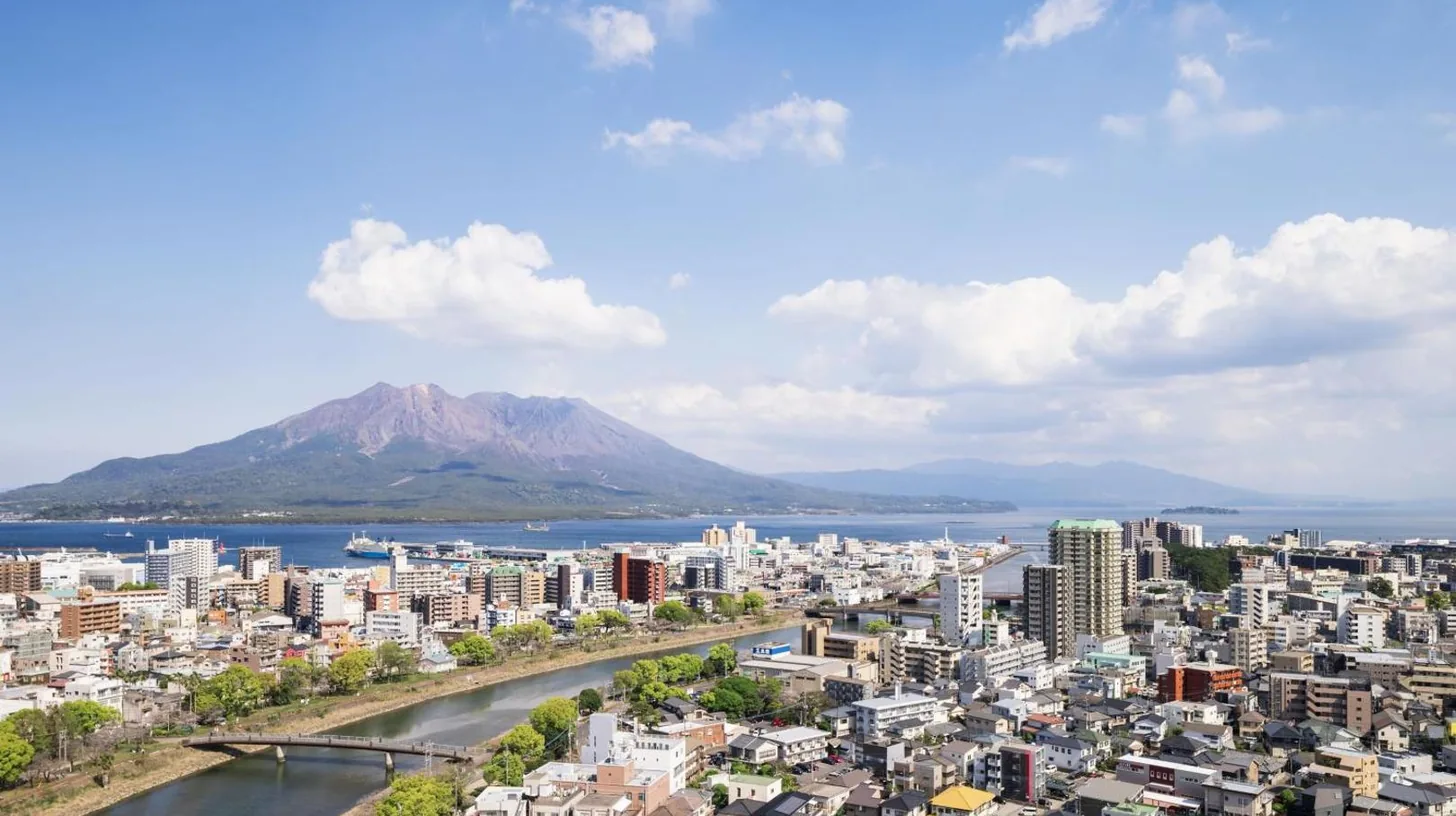 a view of a city with a mountain in the background at Sheraton Kagoshima in Kagoshima