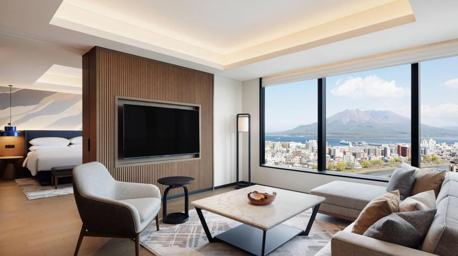 a living room with a couch and a tv at Sheraton Kagoshima in Kagoshima